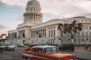 car passing government building in Cuba
