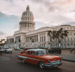 car passing government building in Cuba