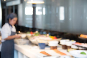 blurred photo of chef preparing food in restaurant kitchen