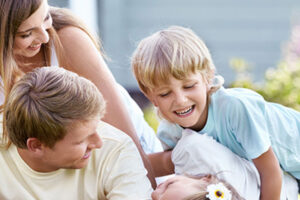 family of four smiling outside