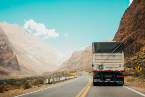 truck driving on road through valley