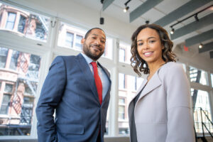 smiling man and woman in business attire