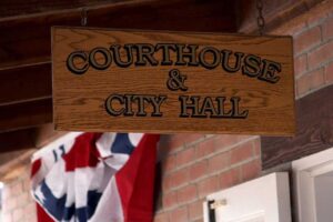 courthouse and city hall wooden sign