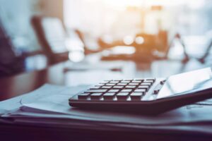 calculator and papers on table