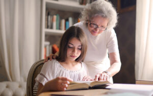 young girl and grandmother reading a book