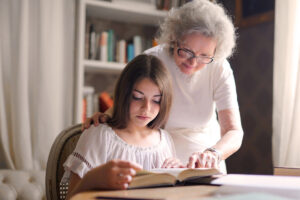 young girl and grandmother reading a book