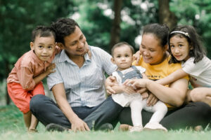 family sitting outside in grass