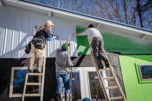 men siding a house