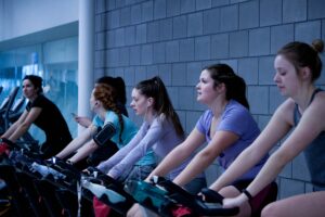 women on stationary bikes in spin class