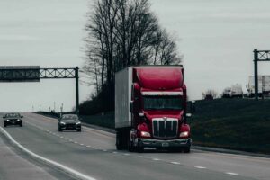 red semi-trailer truck on interstate highway